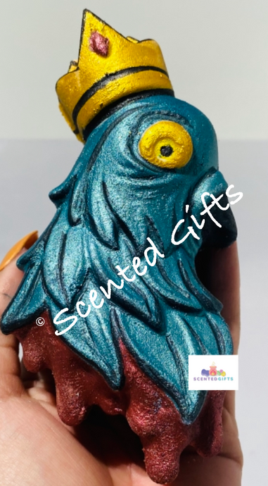 King cluck bath bomb,  packed with blue, green & pink and fragranced in blush naked (lenora dupe). parrot shaped bath bomb, hand painted in blue,red, yellow.