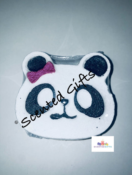 Cute Panda bath bomb A cute white panda shaped bath bomb with black hand painted detail with blue and purple embeds, scented in black raspberry and vanilla.