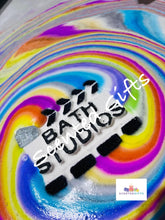 Load image into Gallery viewer, Bath Studios bath bomb  A white and black bath studios action shaped bath bomb scented in fruity and fun raspberry crush fragrance with hidden rainbow colours. Weighing in at 200g approx.
