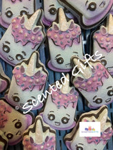 Load image into Gallery viewer, Unicorn Cupcake shaped Bath Bomb A chunky shaped unicorn cupcake bath bomb with hand painted detail, coloured embeds and scented in baby powder.
